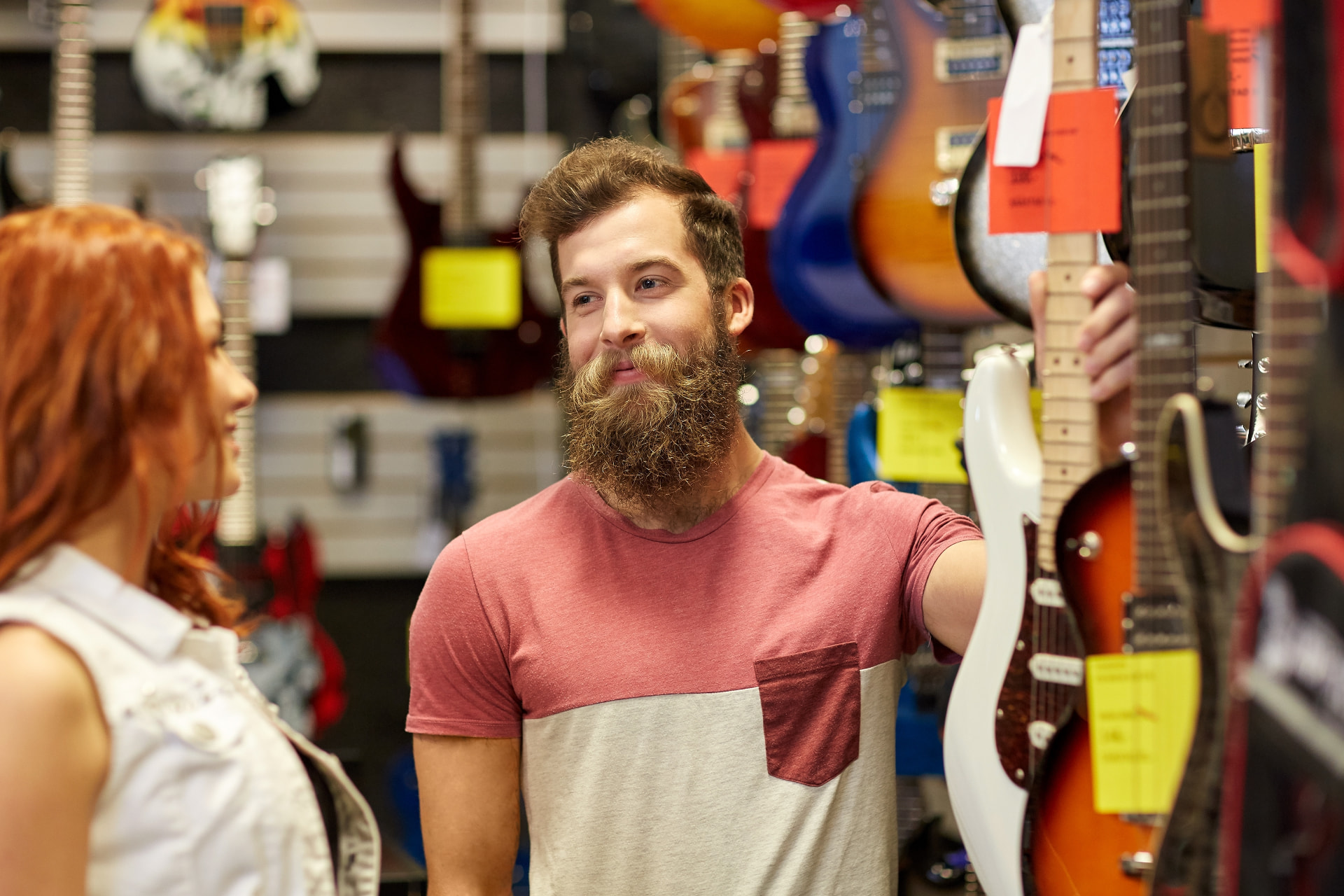 Musicians shopping for guitars in a music store