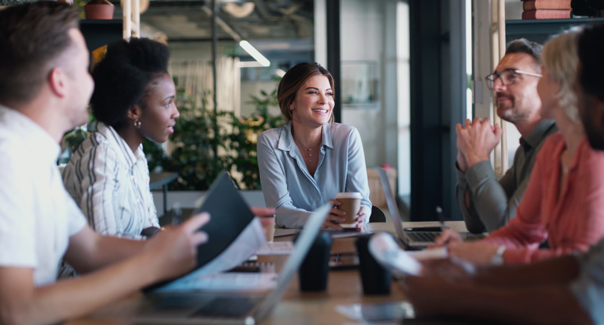 Employees meeting around a conference table to review group benefits